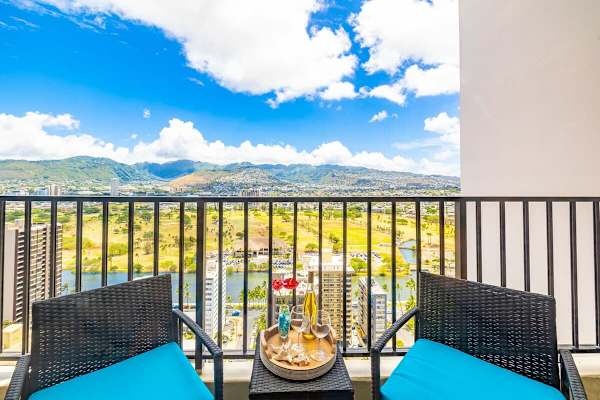 Relax on the balcony with mountain and city views in this bright setting.