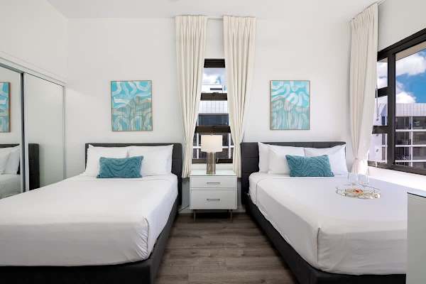 The bedroom has 1 queen-size and 1 full-size bed