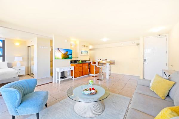 Bright open-concept living area with modern seating and a dining bar.