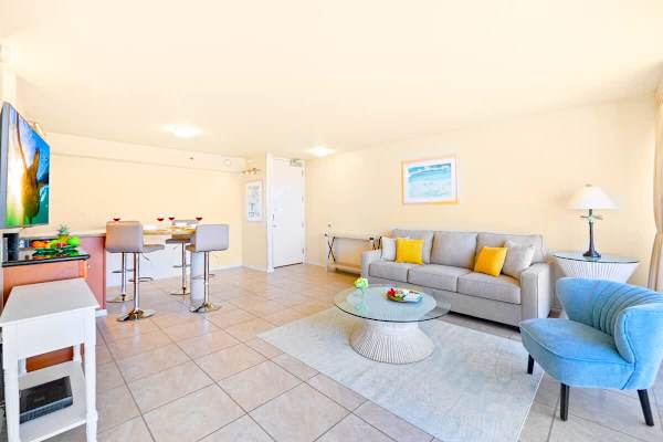 Bright living area with modern seating and a glass coffee table.