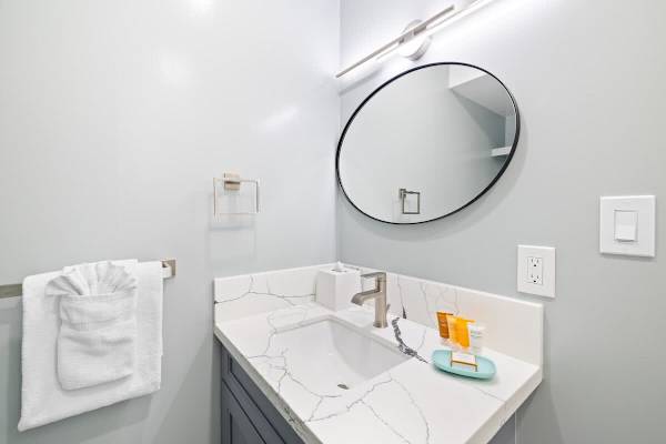 The bathroom has a vanity with cabinet!