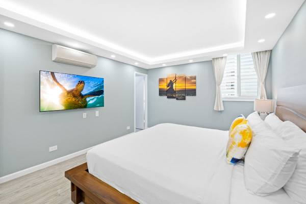 Enjoy watching your favorite shows while resting on a king-size bed in the master bedroom!