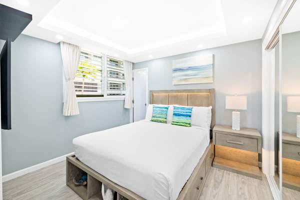 The guest bedroom features a queen-size bed, nightstand, flat screen TV, own bathroom and a split AC!