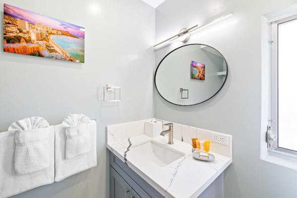 The bathroom has a vanity with cabinet!