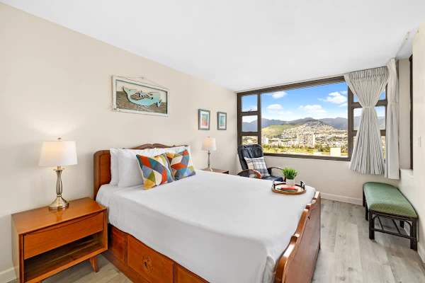 Bedroom with a queen-size bed, lazy boy chair and nightstands