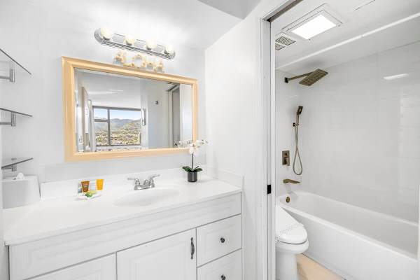 Newly renovated bathroom with tub and shower combination.