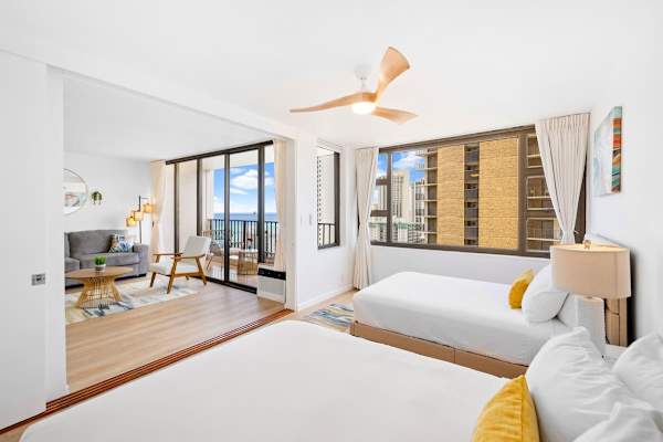 The bedroom features a queen-size and a full-size bed, and a ceiling fan with light