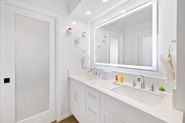 The full bathroom has a beautiful vanity with cabinet!