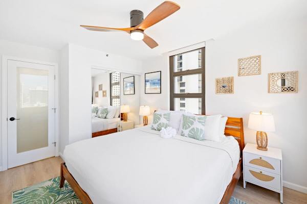 The bedroom has a king-size bed, ceiling fan, nightstands, and closet!