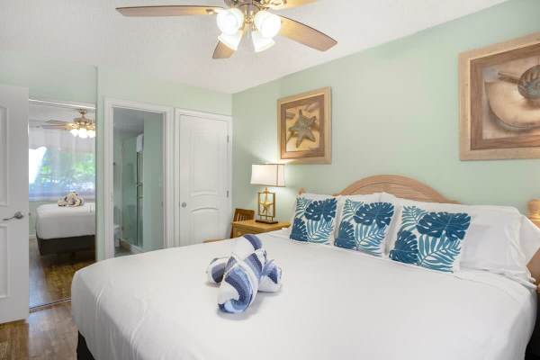 Bedroom with king-size bed, dresser, and own bathroom with a walk-in shower