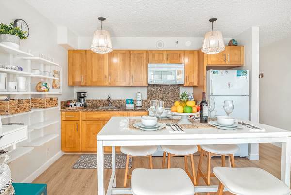 Fully equipped kitchen with full-size appliances, plus dining table with 5 bar stools, cabinets, and shelves for your kitchen utensils.