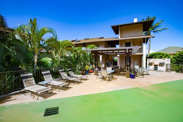 Enjoy sunny outdoor living at the resort's pool deck and pavilion, featuring lounge chairs, shaded dining areas, and outdoor BBQ stations.