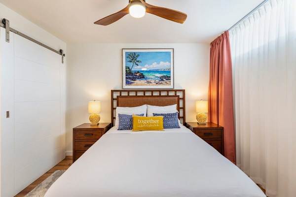 Bedroom 2 with ceiling fan, split AC, and 2 nightstands.