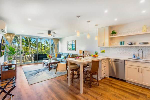 Kitchen and dining area with countertop and 4 bar stools. 