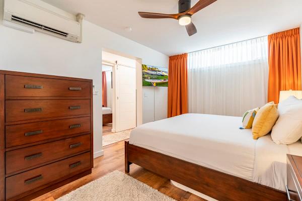 Main bedroom with split AC, 50" Smart TV and ceiling fan