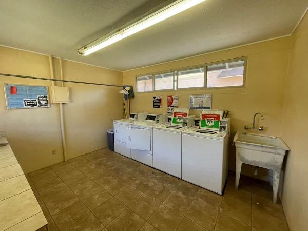 Laundry room at the backyard of the property with washers and dryers. You can pay using mobile phone app or with coins.
