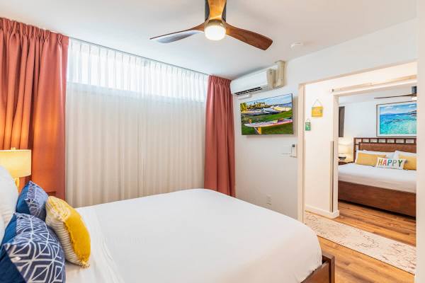 Bedroom 2 with ceiling fan and split AC, and queen-size bed.
