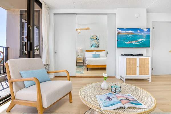 A comfortable chair, coffee table, and flatscreen TV in the living room.