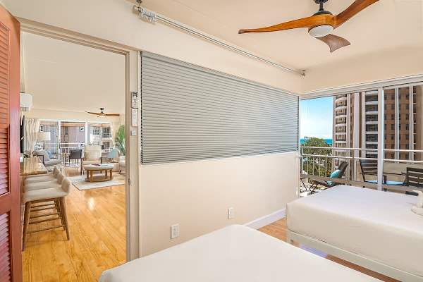 The second bedroom with cabinets and a ceiling fan, motorized window blinds offers the option of having privacy or connecting the room and view to the rest of the living space.