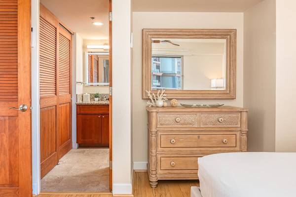 Master bedroom with bathroom, cabinets and mirror