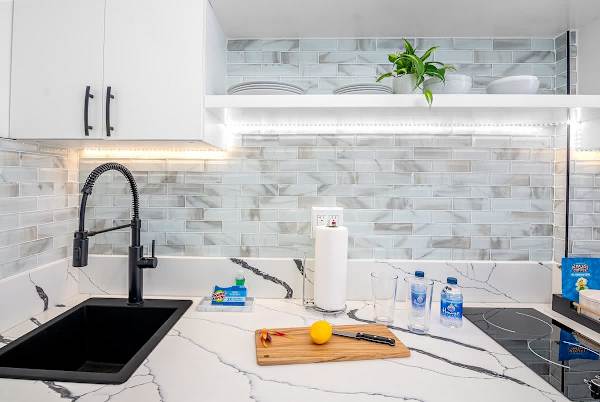 Kitchen with 2 burner cooktops, microwave with power convection oven, and mini fridge.