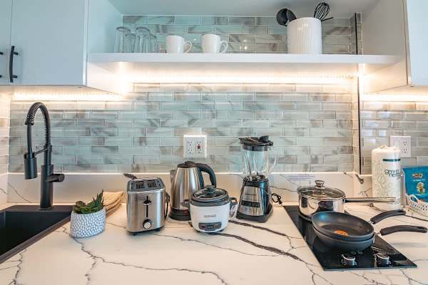 Kitchen with 2 burner cooktops, microwave with power convection oven, and mini fridge.