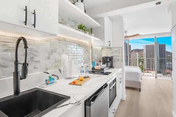 Kitchen with 2 burner cooktops, microwave with power convection oven, and mini fridge.