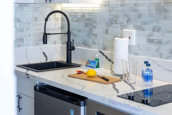 Kitchen with 2 burner cooktops, microwave with power convection oven, and mini fridge.