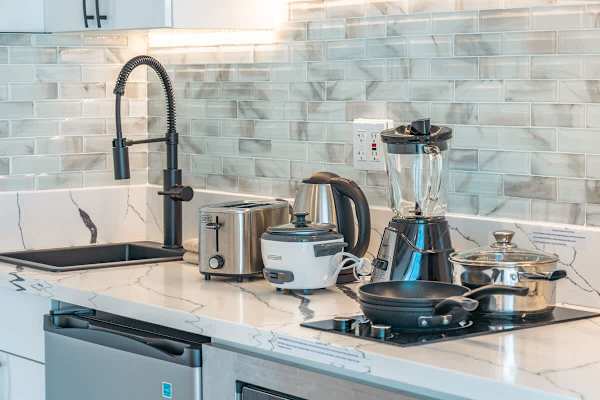 Kitchen with 2 burner cooktops, microwave with power convection oven, and mini fridge.