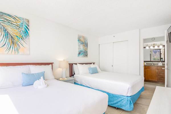 Bedroom with 1 queen-size and 1 full-size bed, dresser, and access to the bathroom.