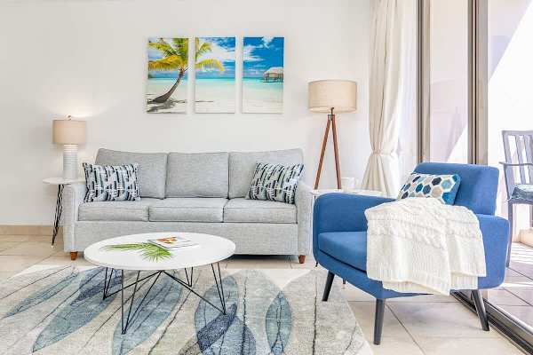 Spacious living room with pull-out sleeper sofa, coffee table, and chair.