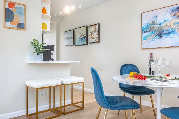 The kitchen has a countertop with 2 bar stools.