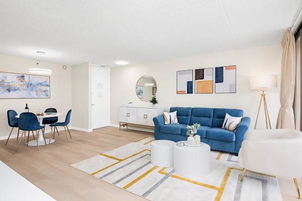 Your spacious living and dining area, with a table and 4 chairs, and a pull-out sleeper sofa, coffee table, and armchair.
