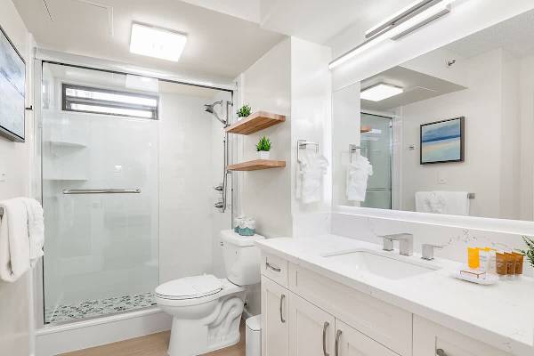 Full bathroom with walk-in shower, and a vanity with a cabinet.