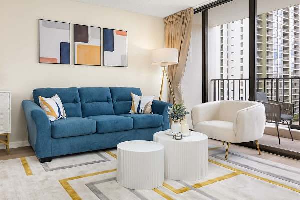 Pull-out sleeper sofa, coffee table, and an armchair in the living room.