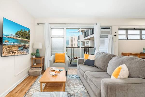 Living room with a queen-size pull-out sleeper sofa, a 75'' smart TV, and a beautiful mountain view.