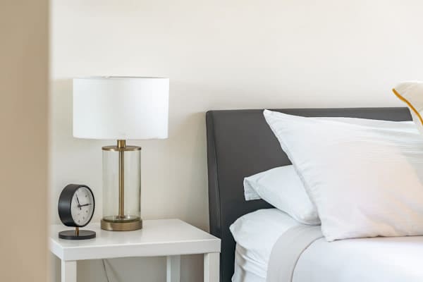 Bedside lamp and clock in you master bedroom
