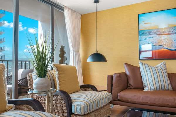 Living room with retro pendant lampshade and 2 armchairs.