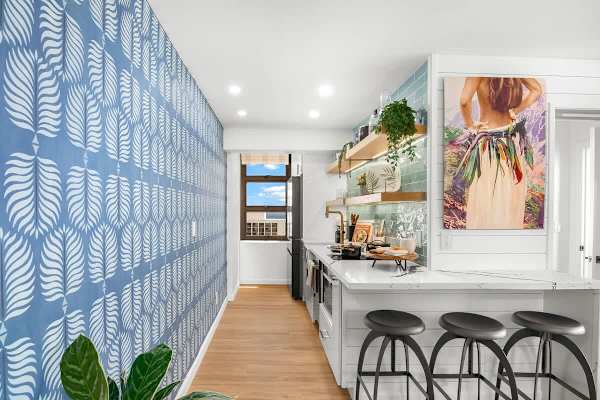 Fully equipped kitchen with counter and 3 bar stools.