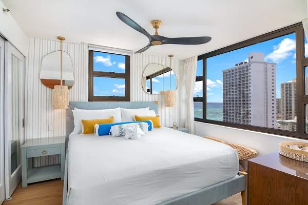 Have a restful night's sleep in your bedroom with a king-size bed, ceiling fan, and ocean views.