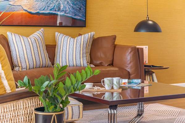 Living room with comfortable sofa, retro pendant lampshade, and coffee table.