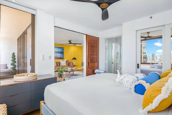 Bedroom with sliding door for added privacy, closet, and access to the bathroom.