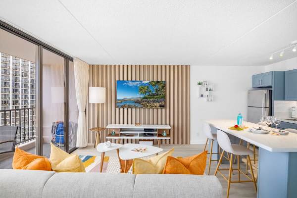 Living room with pull-out sleeper sofa, coffee table, and a 65'' Samsung Smart TV.