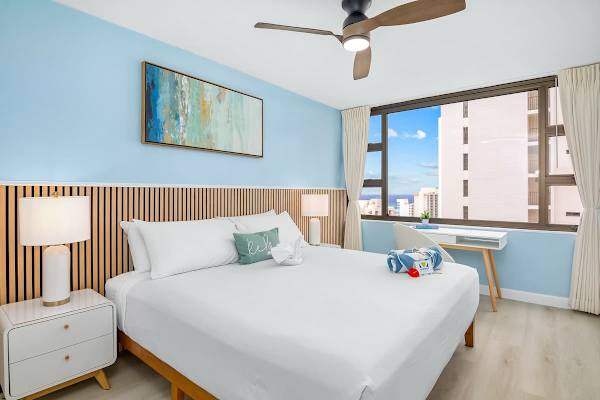 Have a restful night's sleep in your bedroom with a king-size bed, ceiling fan, and ocean view.