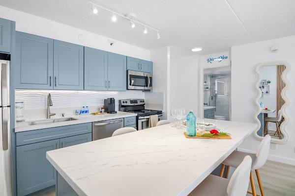 Cook your favorite meals in your fully equipped kitchen perfect for your culinary needs. Plus, share it with loved ones in your dining area with 4 bar stools.