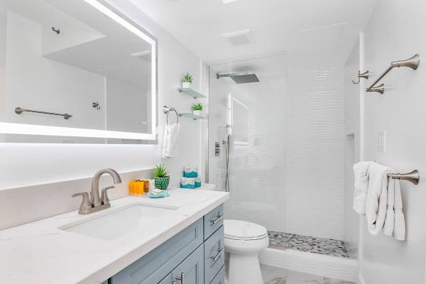 Refreshed in your bathroom with a walk-in shower and a vanity with a cabinet.