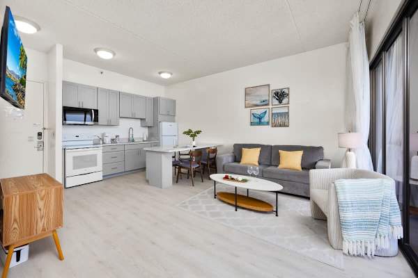 Overview of the living room, dining area, and full kitchen