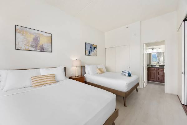 Bedroom with queen-size and full-size beds plus access to the bathroom
