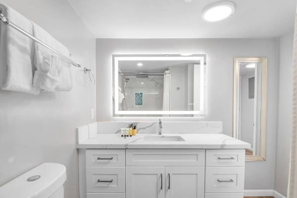 The bathroom with a vanity and cabinet.