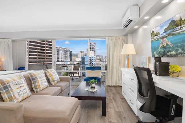 Your living area with a regular sectional sofa, coffee table, an office desk with drawers, and an ergonomic office chair. Plus a 43'' smart TV.